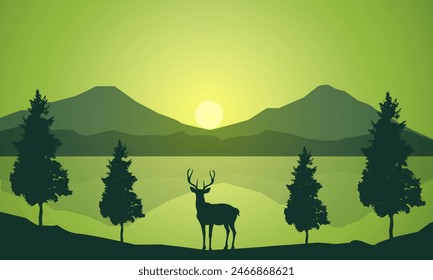 Silhouette of wild deer with trees on the edge of the lake and beautiful mountains in the morning,evening, sunset,sunrise