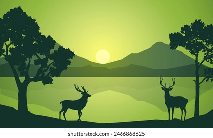 Silhouette of wild deer with trees on the edge of the lake and beautiful mountains in the morning,evening, sunset,sunrise