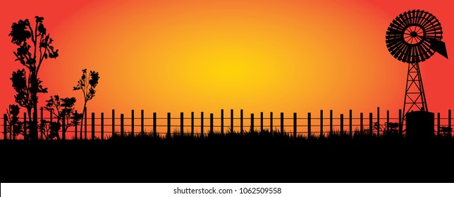 Silhouette Of Wind Mill In The Outback With Bright Orange Sunset