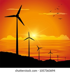 silhouette of wind turbines and sea in the sunset background