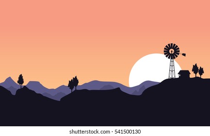 Silhouette of windmill and house landscape