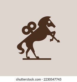 A silhouette of a wind-up toy horse with a winding key on its back rearing on its hind legs.