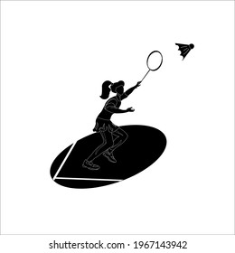 Silhouette of a woman athlete in badminton, who hit the shuttlecock off the opponent's serve on the playing court with a racket