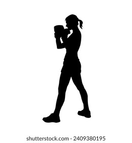 Silhouette of woman boxing athlete in action pose. Silhouette of a female wearing boxing gloves for boxing sport.