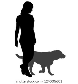 Silhouette of a woman with a dog on a walk