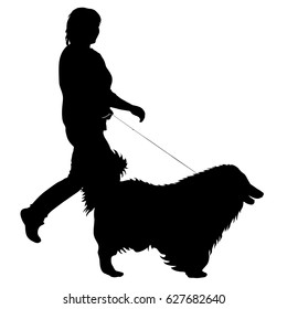 Silhouette of woman and dog on a white background.