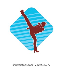 Silhouette of a woman doing a martial art kick. Silhouette of a sporty female doing kicking movement.
