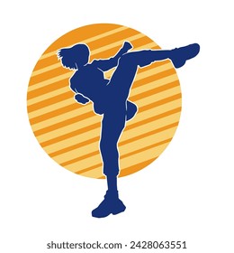 Silhouette of a woman doing a martial art kick. Silhouette of a sporty female doing kicking movement.