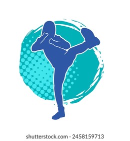 Silhouette of a woman doing a martial art kick. Silhouette of a sporty female doing kicking movement.