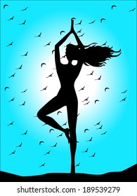 silhouette of woman doing yoga on blue sky background 