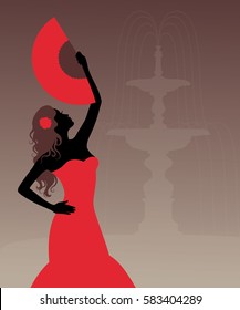 Silhouette of a woman in flamenco costume. Fountain on the background. 