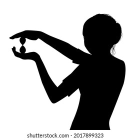 Silhouette of woman holding a hourglass in her hands