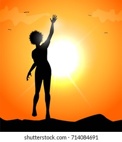 silhouette of a woman laughing at sunset