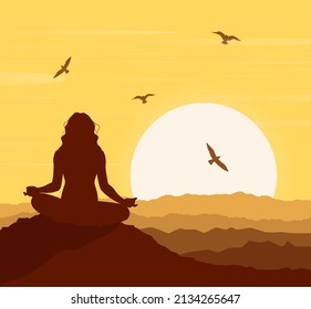 A silhouette of a woman in a lotus pose against a sunset background. Zen, meditation, silhouette of woman practicing yoga lotus position in sunset. Oneness with nature