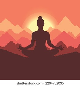 Silhouette of a woman meditating in the mountains at sunrise