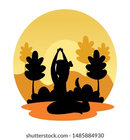 silhouette of woman practicing pilates on the landscape sunset scene