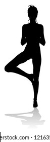 A silhouette of a woman in a yoga or pilates pose 