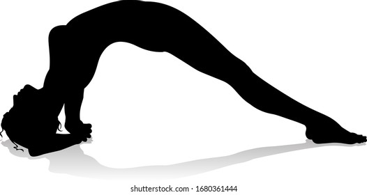 A silhouette of a woman in a yoga or pilates pose 