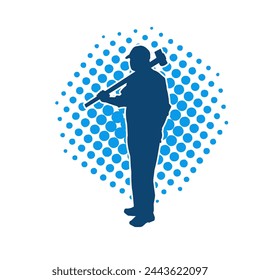 Silhouette of a worker in action pose using his sledge hammer tool.