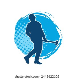 Silhouette of a worker in action pose using his sledge hammer tool.