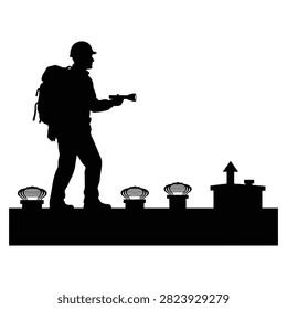 Silhouette of a worker with a backpack and flashlight on a rooftop at night