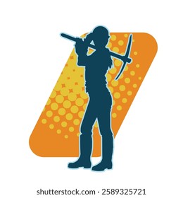 silhouette of a worker swinging a mattock tool. silhouette of a male labour wearing safety helmet holding grub axe.