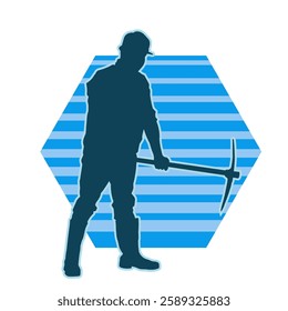 silhouette of a worker swinging a mattock tool. silhouette of a male labour wearing safety helmet holding grub axe.