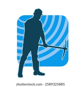 silhouette of a worker swinging a mattock tool. silhouette of a male labour wearing safety helmet holding grub axe.