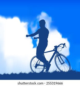 Silhouette of a wrong cyclist on the background of blue sky with clouds