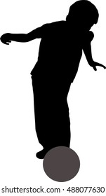 Silhouette of young boy playing football