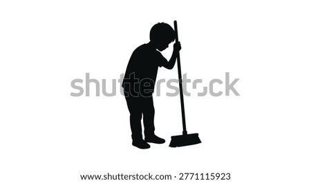 Silhouette of a young boy sweeping the floor with a broom