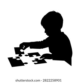 A silhouette of a young child focused on assembling a jigsaw puzzle