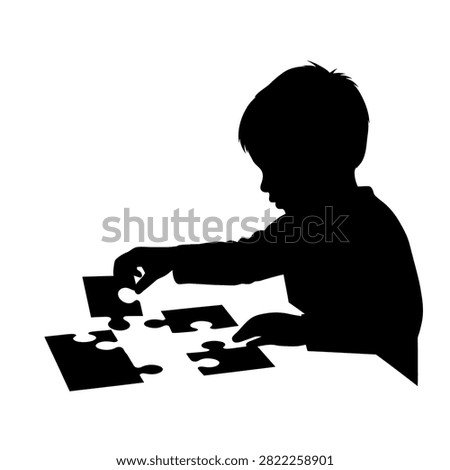 A silhouette of a young child focused on assembling a jigsaw puzzle