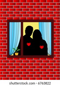 Silhouette of young couple embracing in a window in the evening