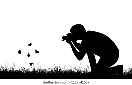 Silhouette of a young man photographing flying butterflies in a lawn - vector