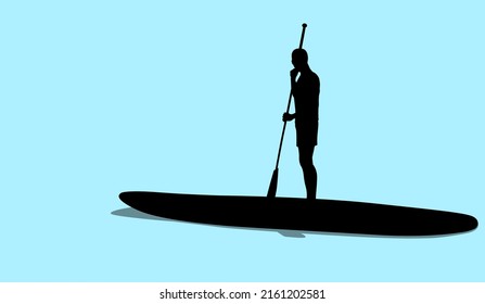 Silhouette of young man standing on sup board floating in sea in sunny day. Tourist learning to paddle and balance on paddle board.