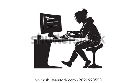 Silhouette of a young woman programmer coding on a computer at her desk in a home office setting