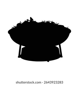A silhouetted charcoal grill filled with vegetables prepared for a bbq dinner celebration