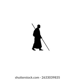 Silhouetted monk walking with staff peaceful journey