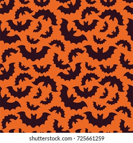 Silhouettes of bats on orange background. Seamless pattern . Halloween background.
