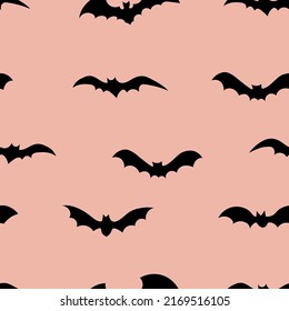 Silhouettes of bats seamless pattern on color background. Halloween design for baby clothes, bedding, textiles, print, wallpaper.