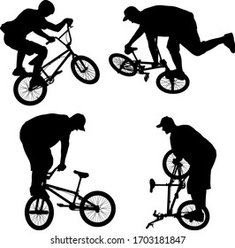 silhouettes of boy doing bike trick on BMX bicycle