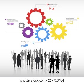Silhouettes of business people discussing and multi-colored gears with global networking themed symbols.