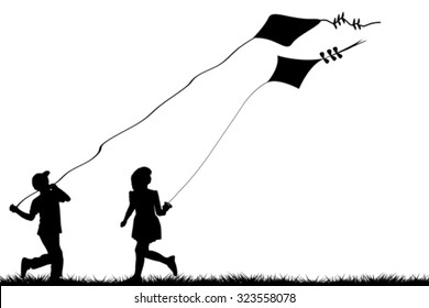 Silhouettes of children flying kites 