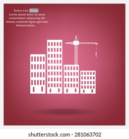 Silhouettes of crane working on buildings