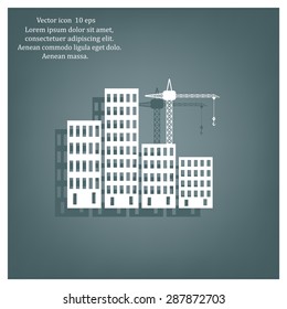 Silhouettes of crane working on the buildings