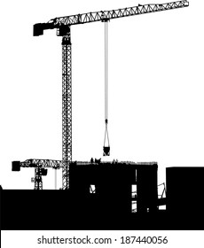 Silhouettes of cranes on building