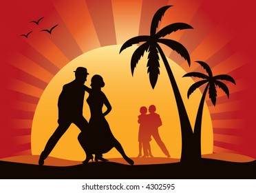 Silhouettes of dancers on a background of a sunset