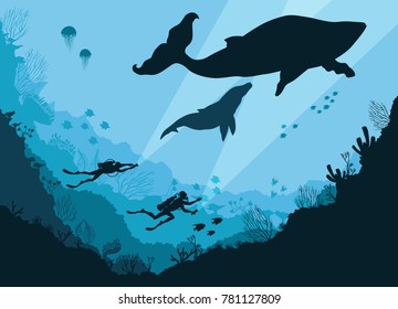 Silhouettes of divers underwater