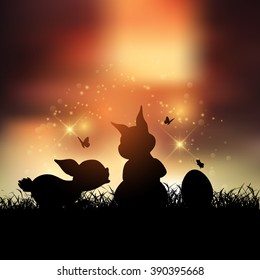Silhouettes of Easter bunnies against a sunset sky